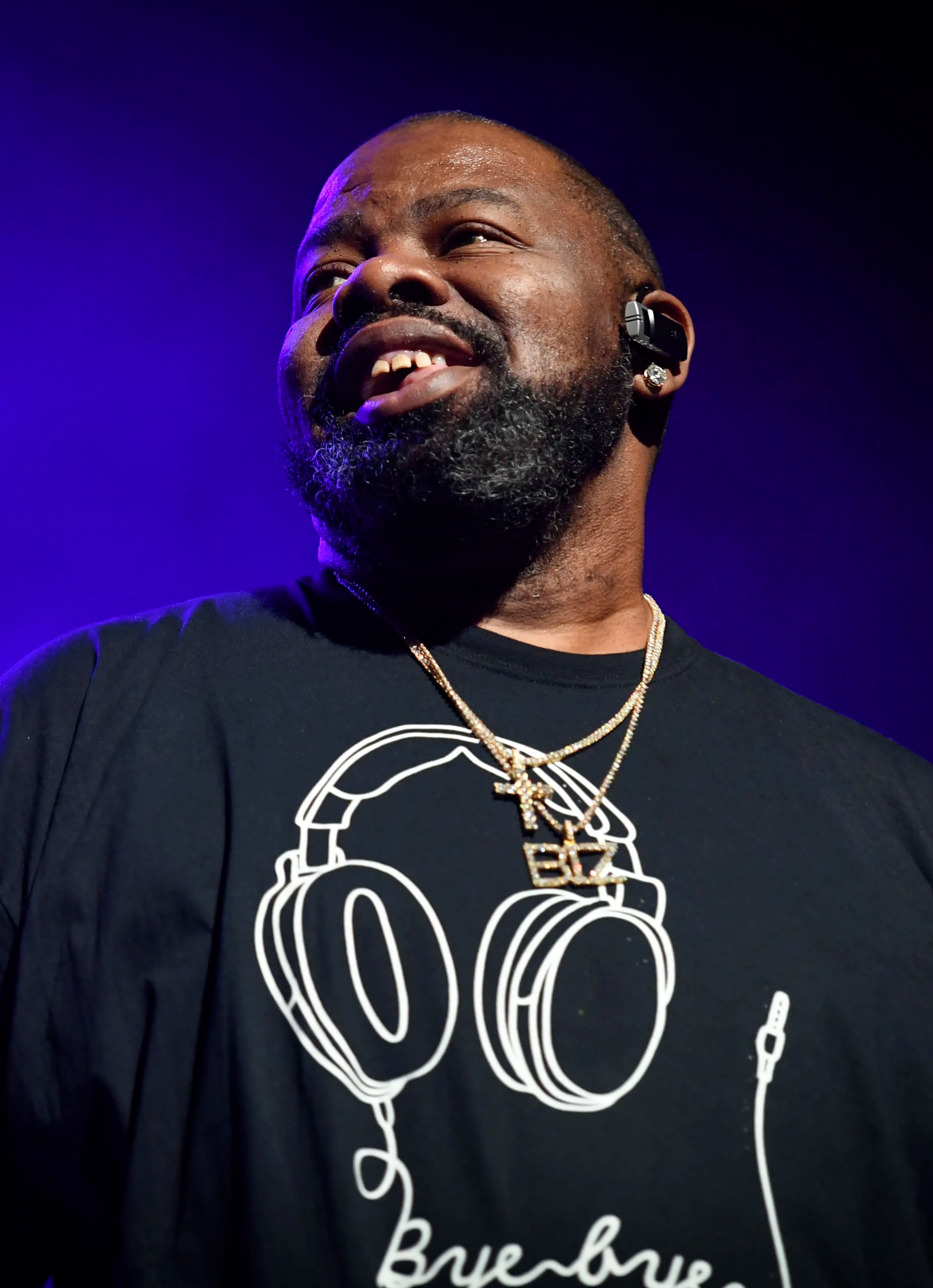 Biz Markie performing on stage with purple lighting